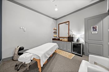 A room with a massage table and a mirror on the wall. at 46 Penn Apartment Homes, Kansas City, MO